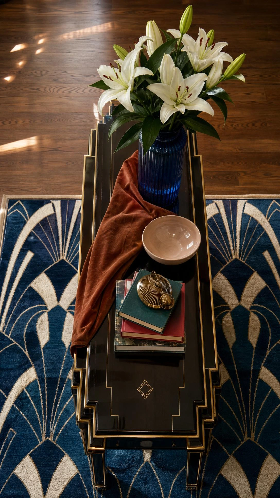 Overhead flat lay of an Art Deco stepped console table in emerald-black lacquer, brass trim, and geometric inlay