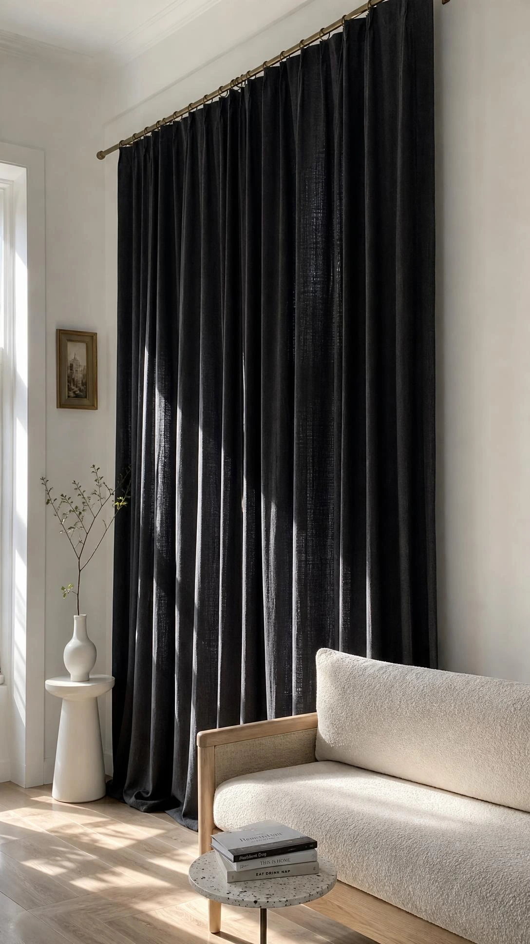 Deep charcoal linen curtains hung floor-to-ceiling in a small city apartment, using dark curtain color to create height and architectural depth rather than visual heaviness