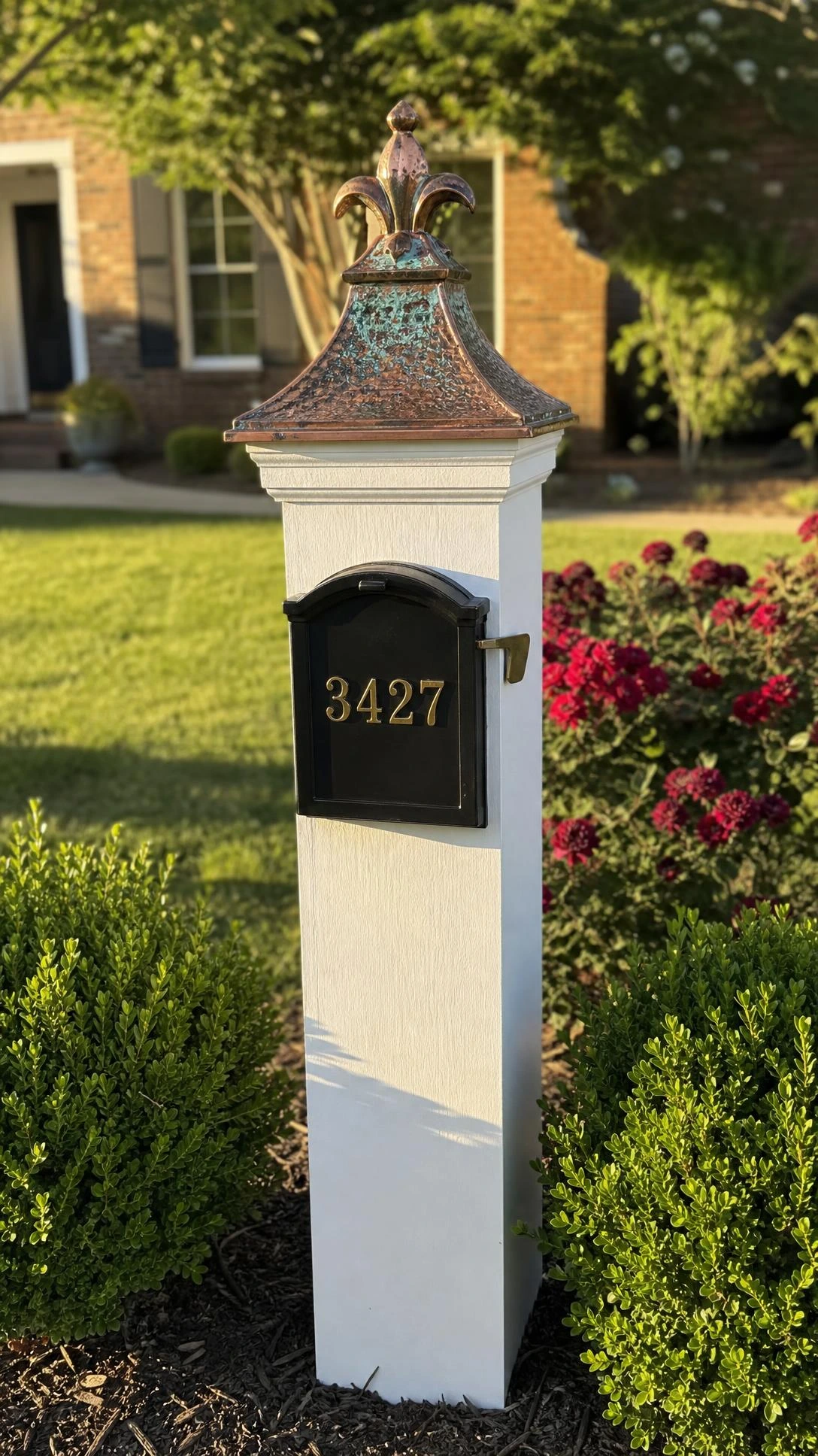 Aged copper finial post cap with verdigris patina and fleur-de-lis crown detail, a small upgrade that transforms mailbox curb appeal instantly