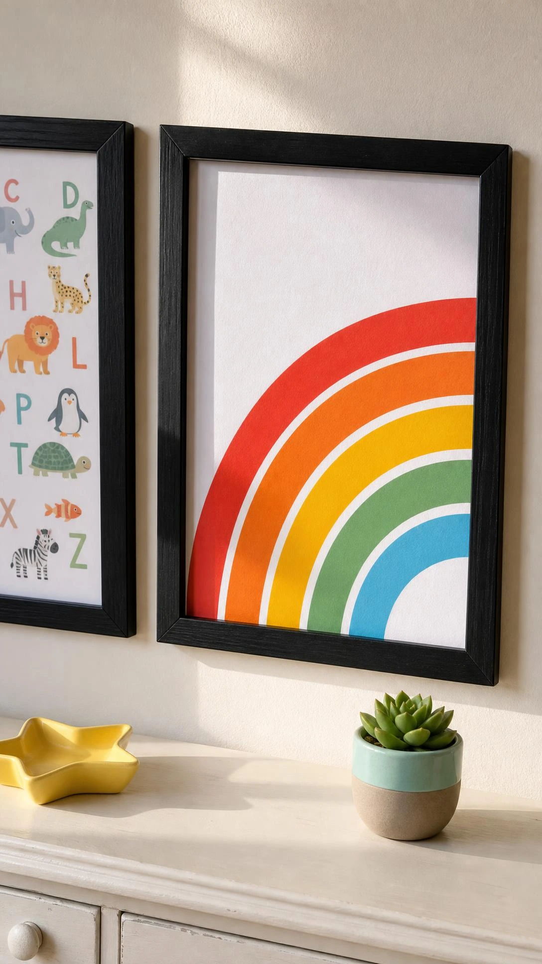 Dollar store black frame on a white wall holding a bold rainbow printable on white cardstock, proving free kids room artwork can look intentional and polished