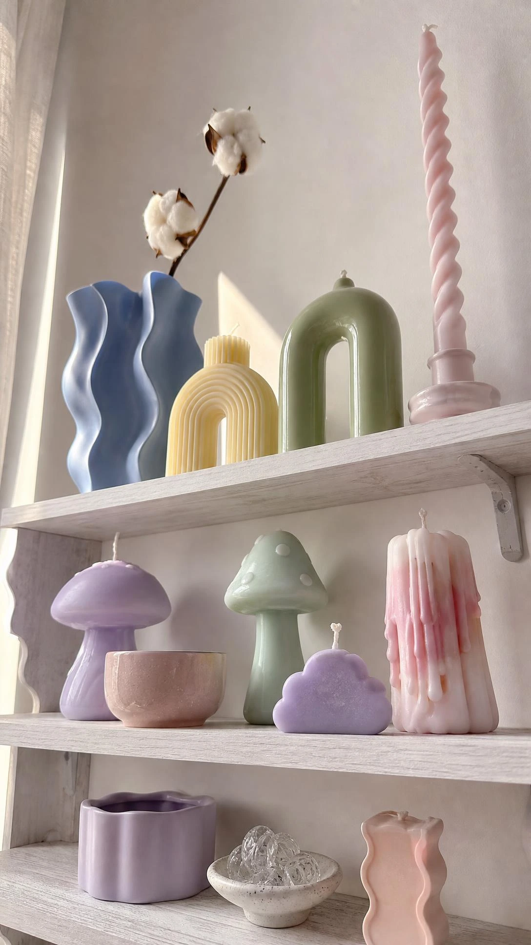 Pastel room aesthetic shelf styled with chunky mushroom candles in lilac and mint, plus a blush spiral taper vase shot from a dramatic low angle