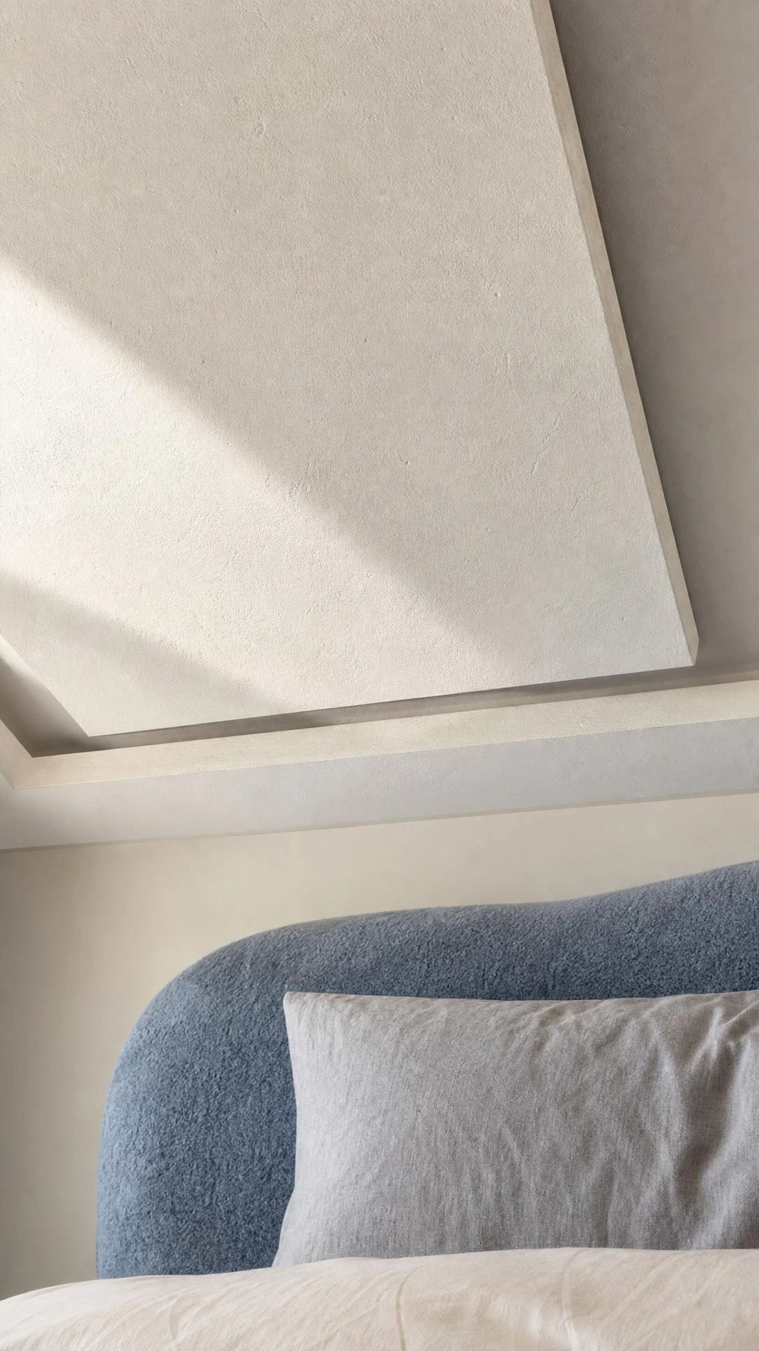 Close-up of gypsum ceiling panel in bedroom showing air cavity gap between layers that provides sound insulation by trapping and dampening noise