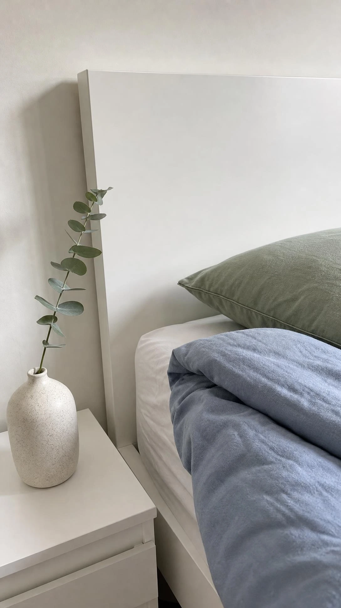 IKEA MALM bed frame in white lacquer showing the clean flat-panel headboard that anchors a neutral bedroom without competing with other decor