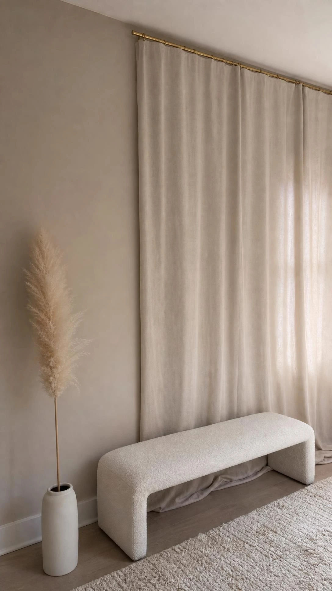 Floor-to-ceiling greige linen curtains blending into a matching greige wall, showing how exact curtain color matching flattens a living room's depth
