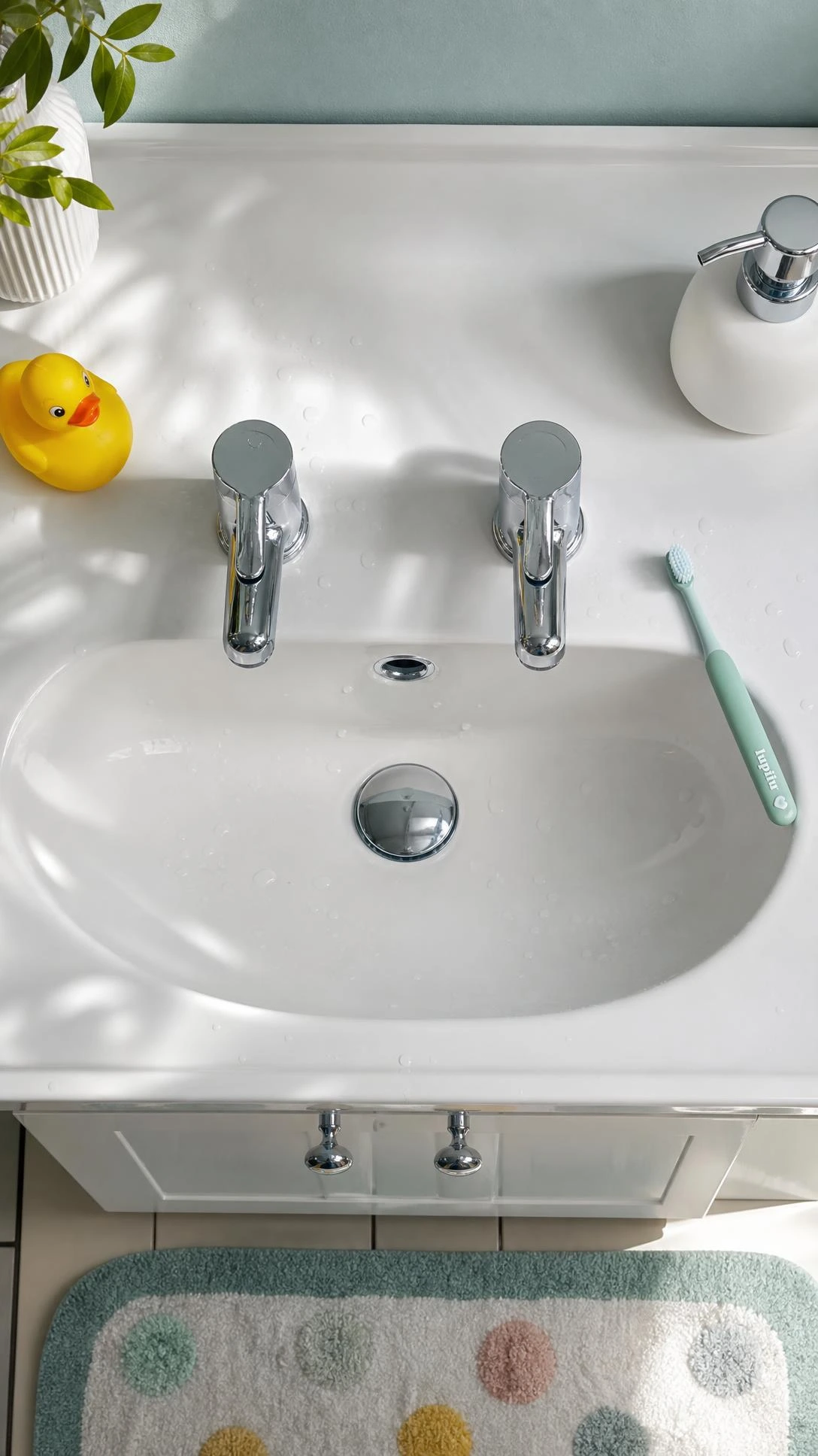 Chrome single-lever mono basin taps on white ceramic sink — easy one-handed operation ideal for young children learning bathroom independence