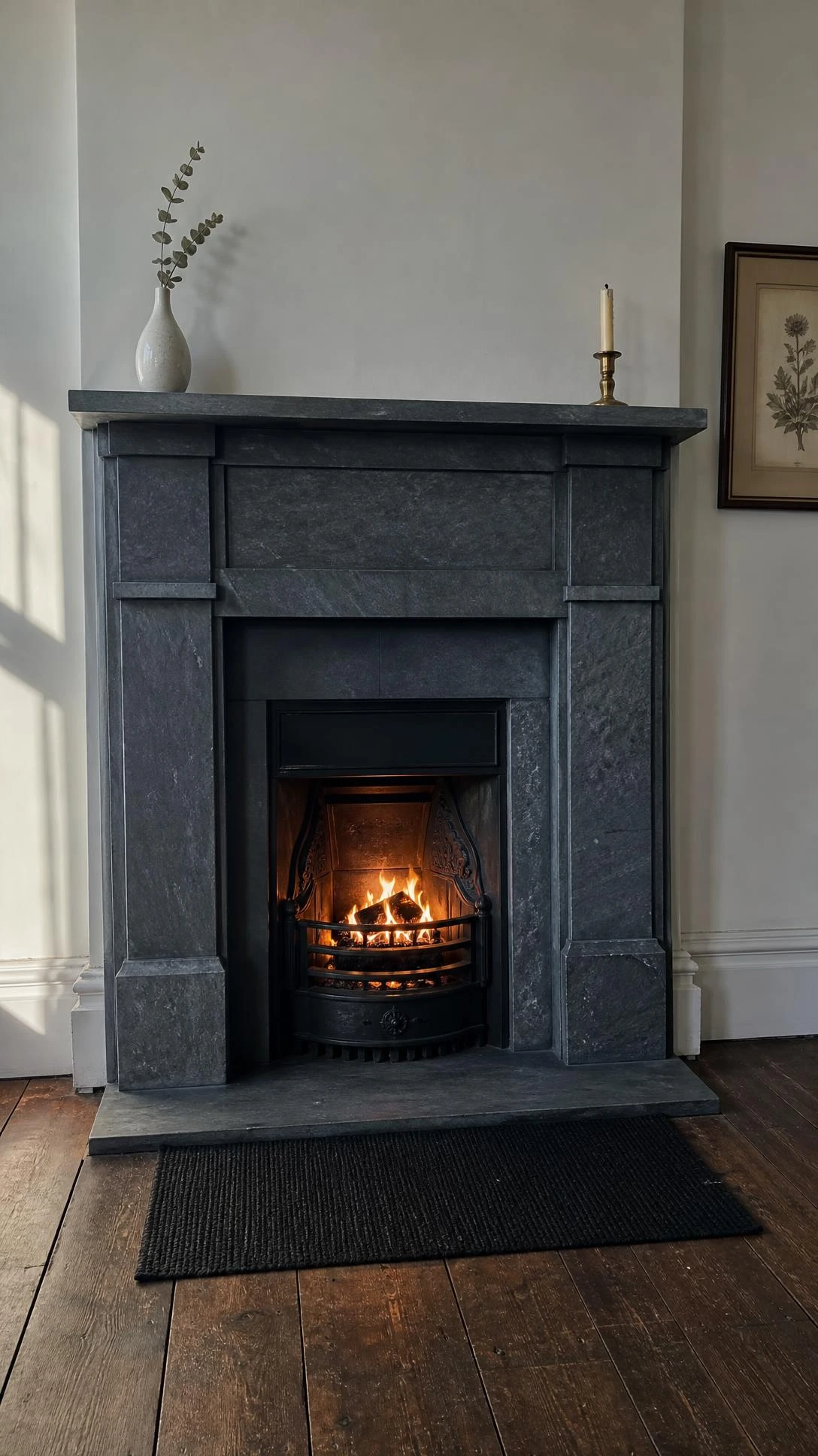 Deep charcoal grey slate Victorian fireplace surround with flat pilasters and rectangular mantelpiece shelf, showing the stone's natural subtle tonal variation from hearth to overmantel