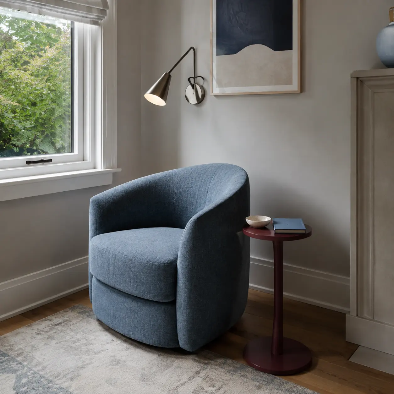 Cozy reading corner with a blue chair beside a bright window