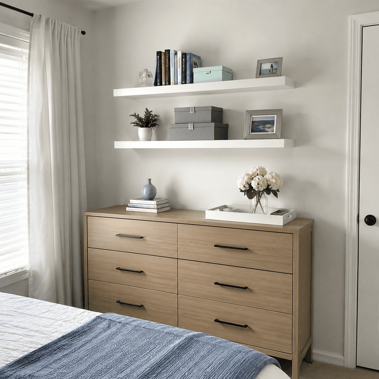 Floating bedroom shelves above a dresser