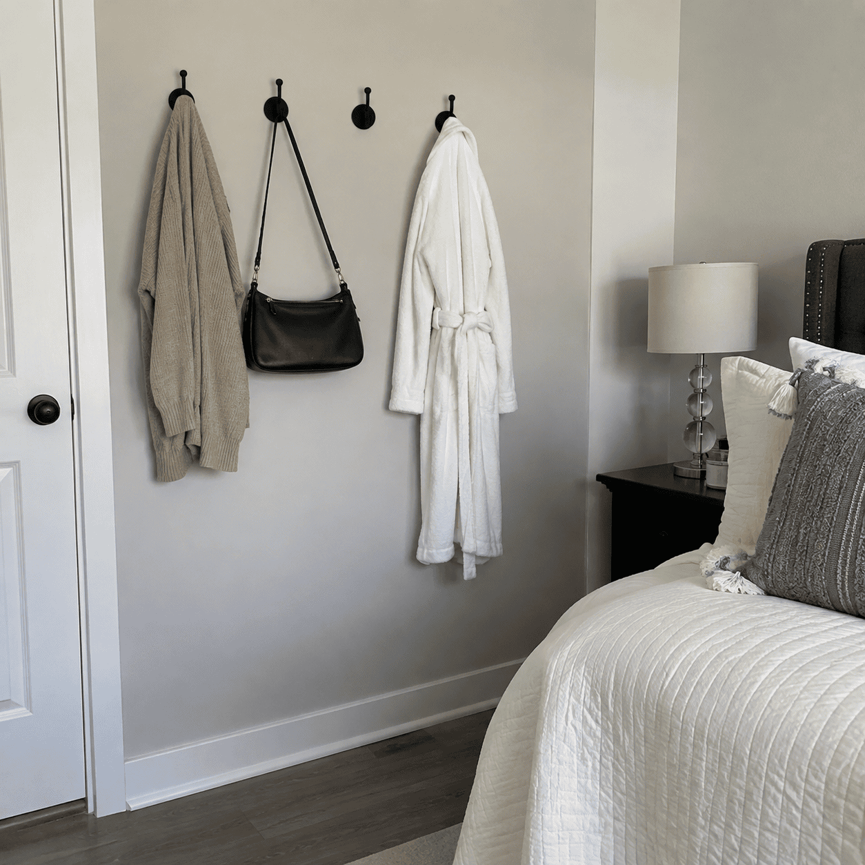 Bedroom wall hooks holding a bag and everyday clothes